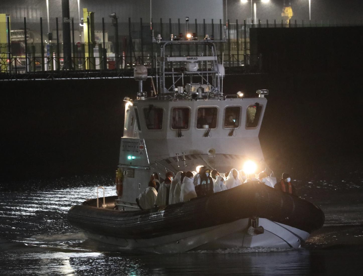 Just in time for Christmas: Young children and a baby girl are among migrants arriving in Dover minutes before midnight after crossing the channel in heavy rain